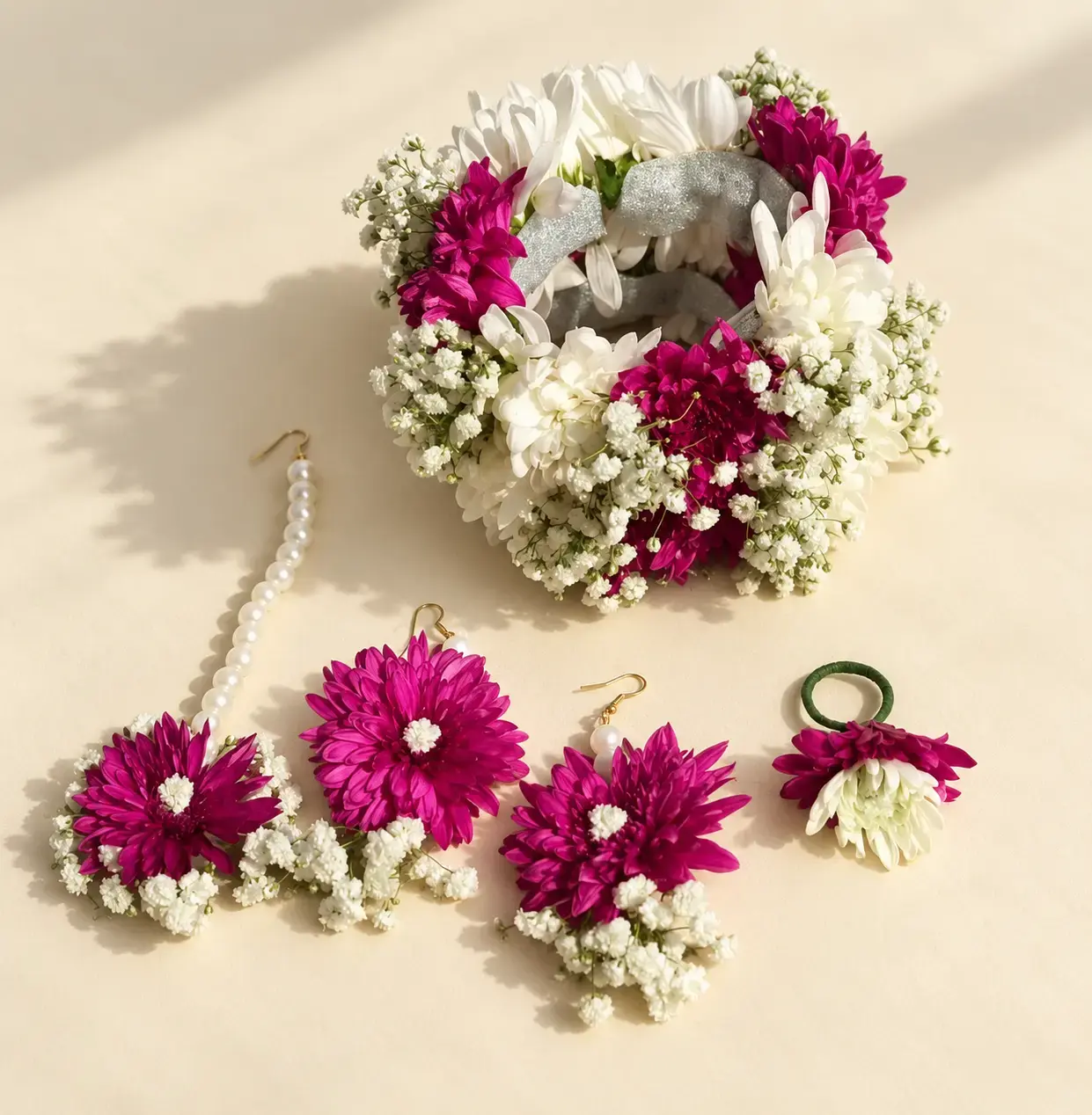 Purple and white guldavri floral jewellery with baby’s breath and pearl-style detailing arranged on an ivory background.