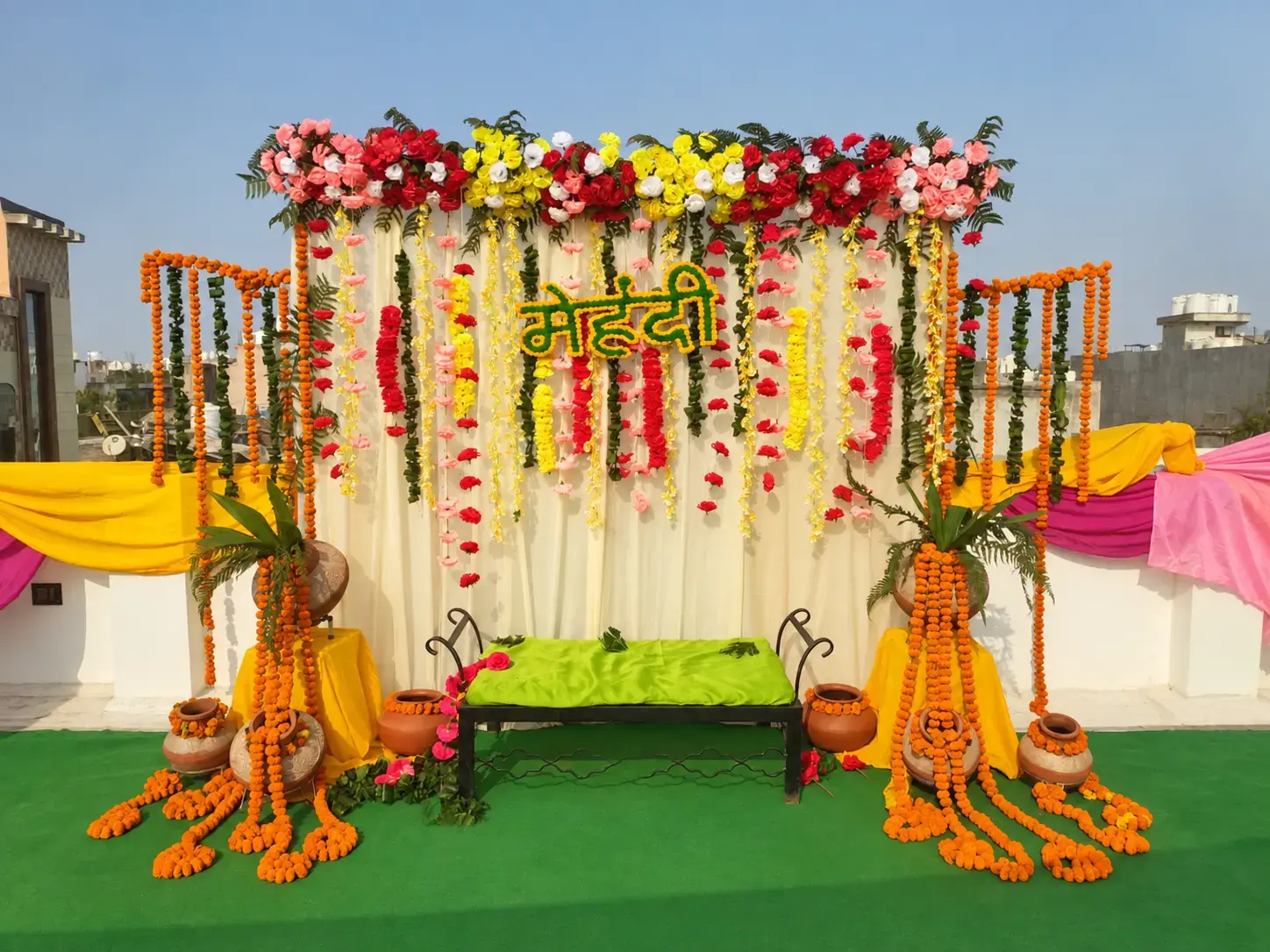 Floral backdrop and seating area for a haldi celebration